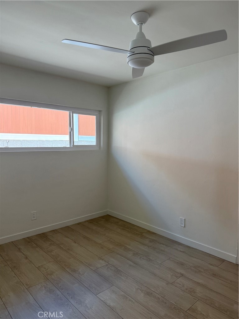 717 Naramore Way Redondo Beach, CA 90278 - Photo 6 of 16 a view of empty room with wooden floor and fan