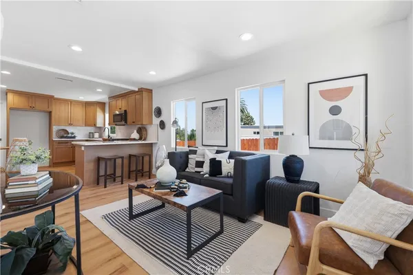 a living room with furniture a rug and a table