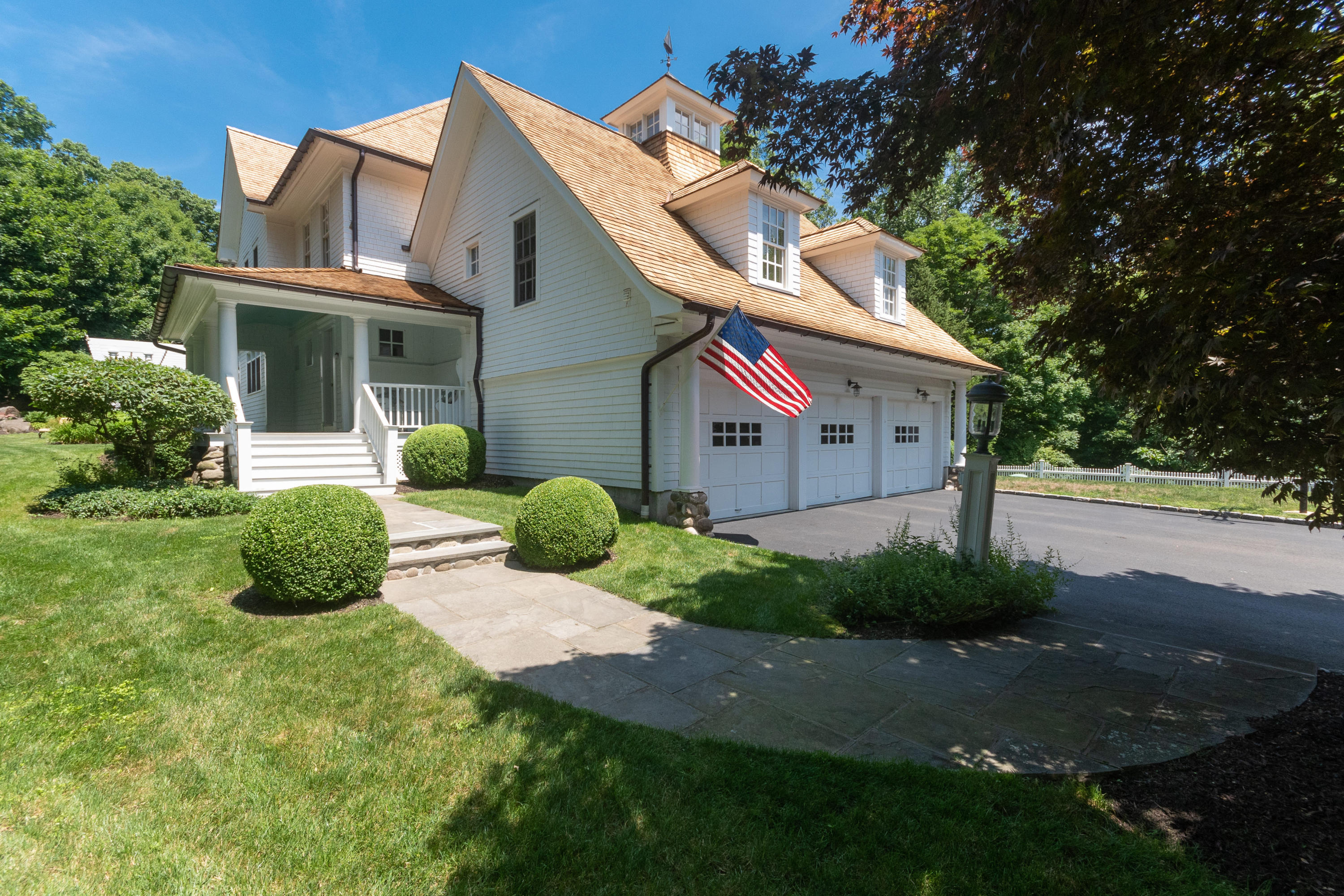 19 Whaling Road Darien, CT 06820 - Photo 3 of 48 a view of a white house with a small yard and plants