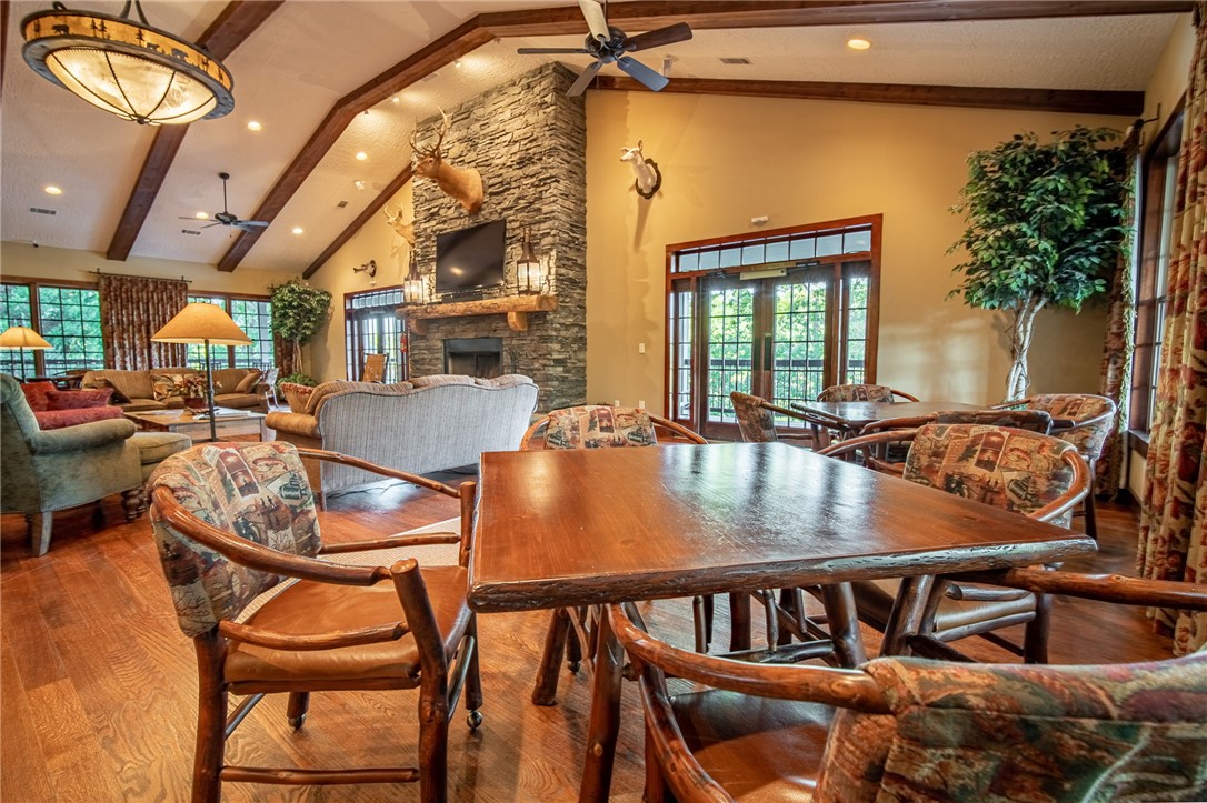 1230 Melton Road, Unit 25 West Union, SC 29696 - Photo 20 of 46 A rustic-inspired great room features vaulted beamed ceilings, hardwood floors, and a commanding stone fireplace.