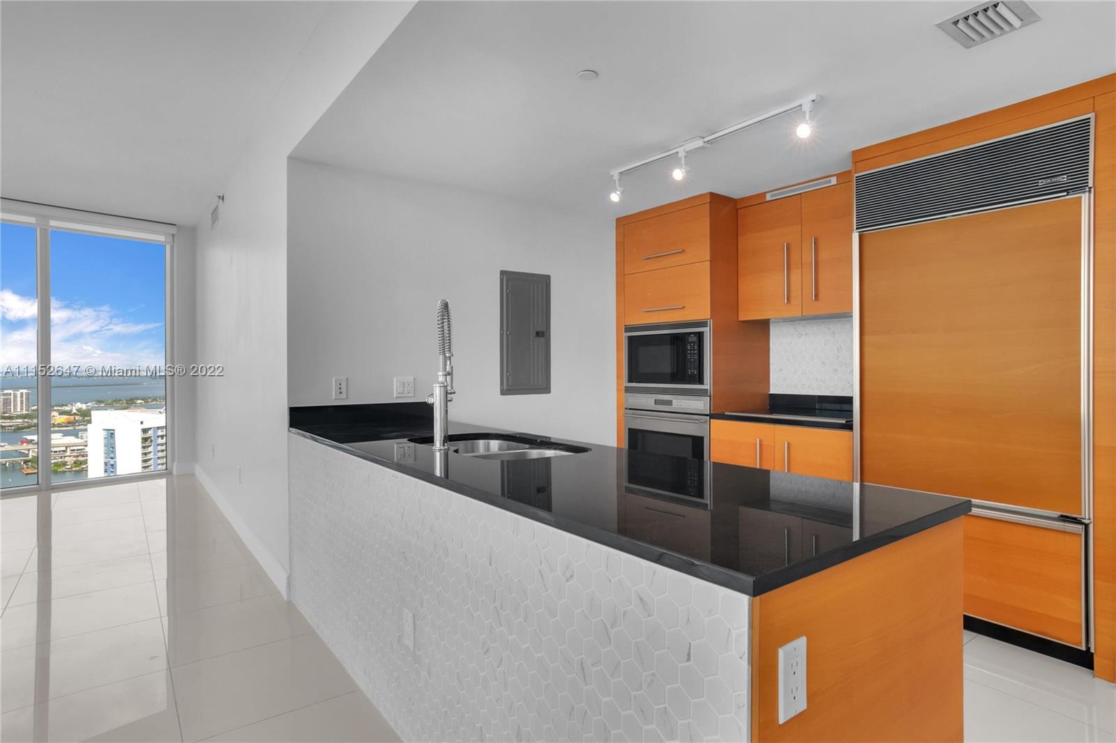 465 Brickell Avenue, Unit 5002 Miami, FL 33131 - Photo 13 of 26 a kitchen with stainless steel appliances granite countertop a sink a stove and a refrigerator