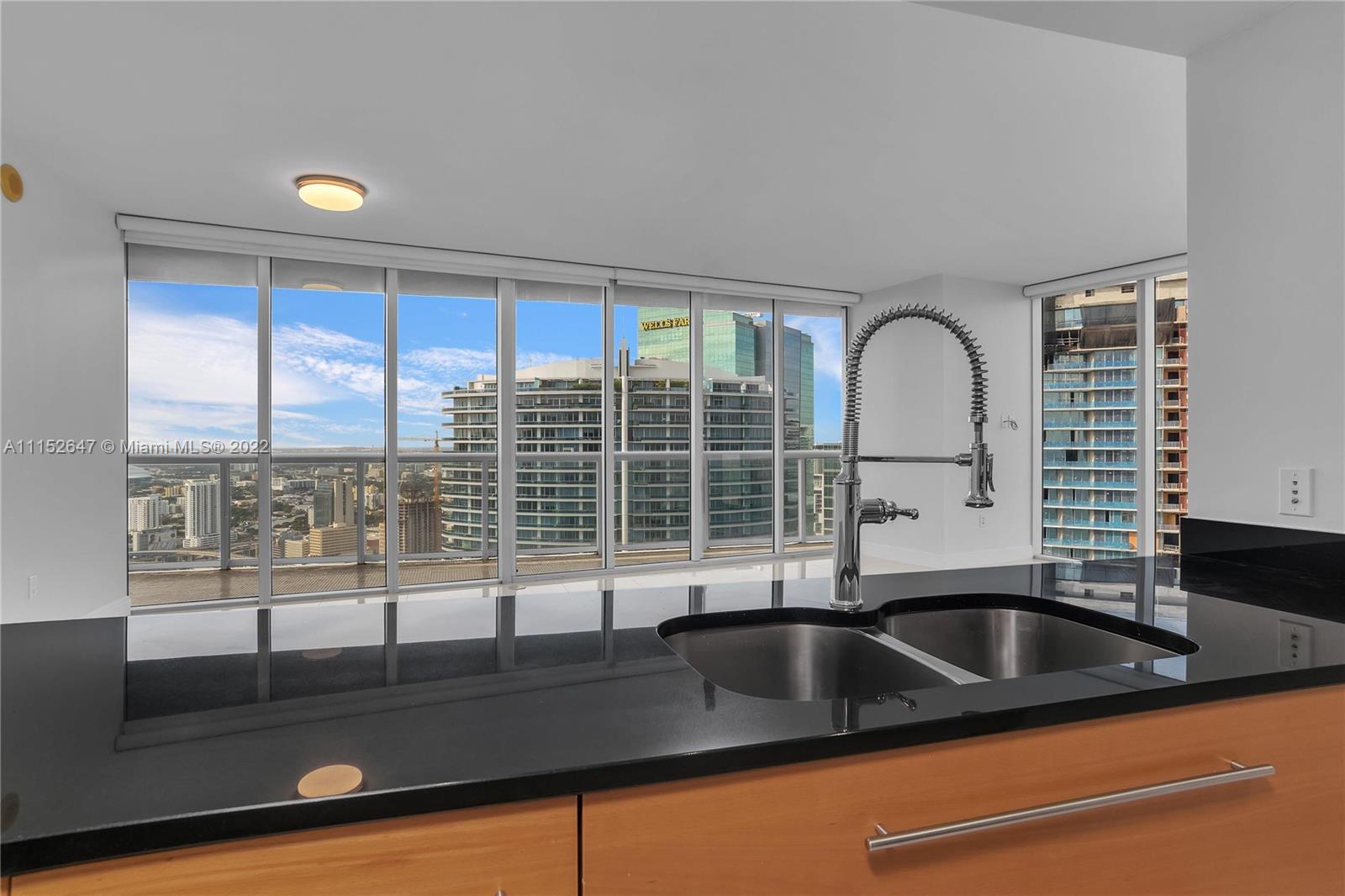 465 Brickell Avenue, Unit 5002 Miami, FL 33131 - Photo 16 of 26 a kitchen with a sink and large window
