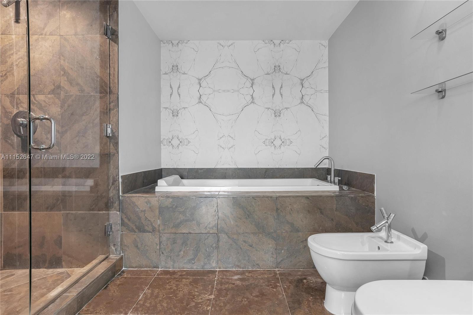 465 Brickell Avenue, Unit 5002 Miami, FL 33131 - Photo 21 of 26 a bathroom with a toilet and a shower