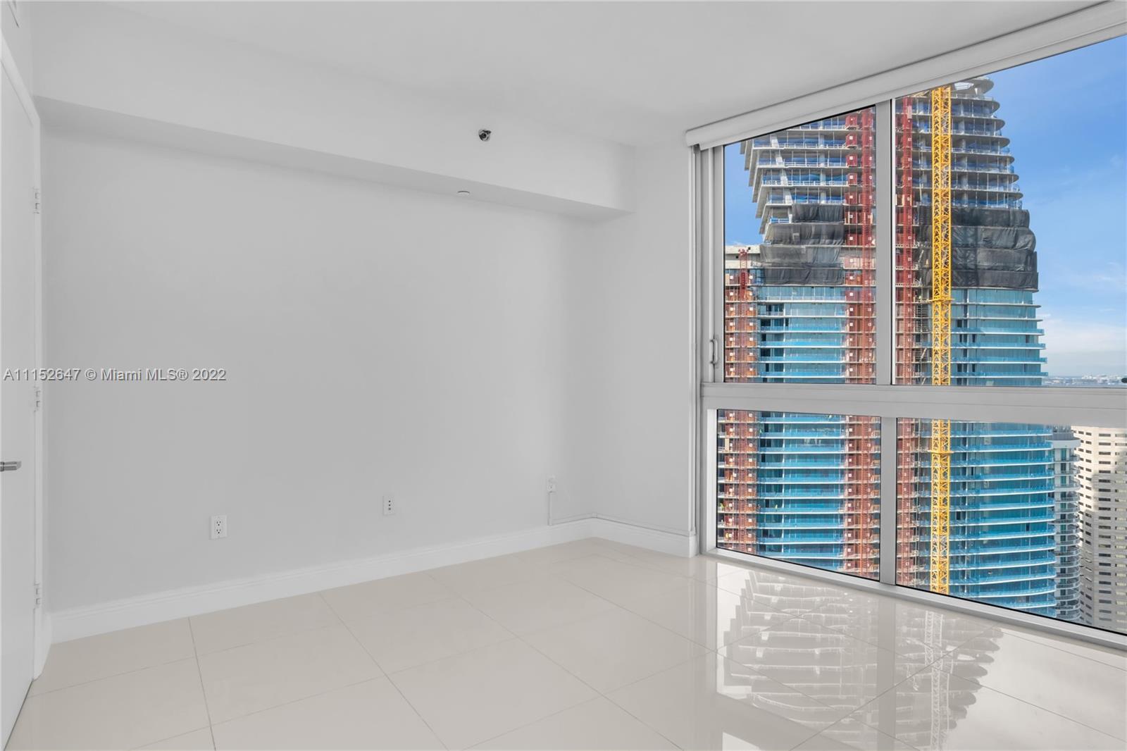 465 Brickell Avenue, Unit 5002 Miami, FL 33131 - Photo 24 of 26 a view of wooden floor and windows in a room