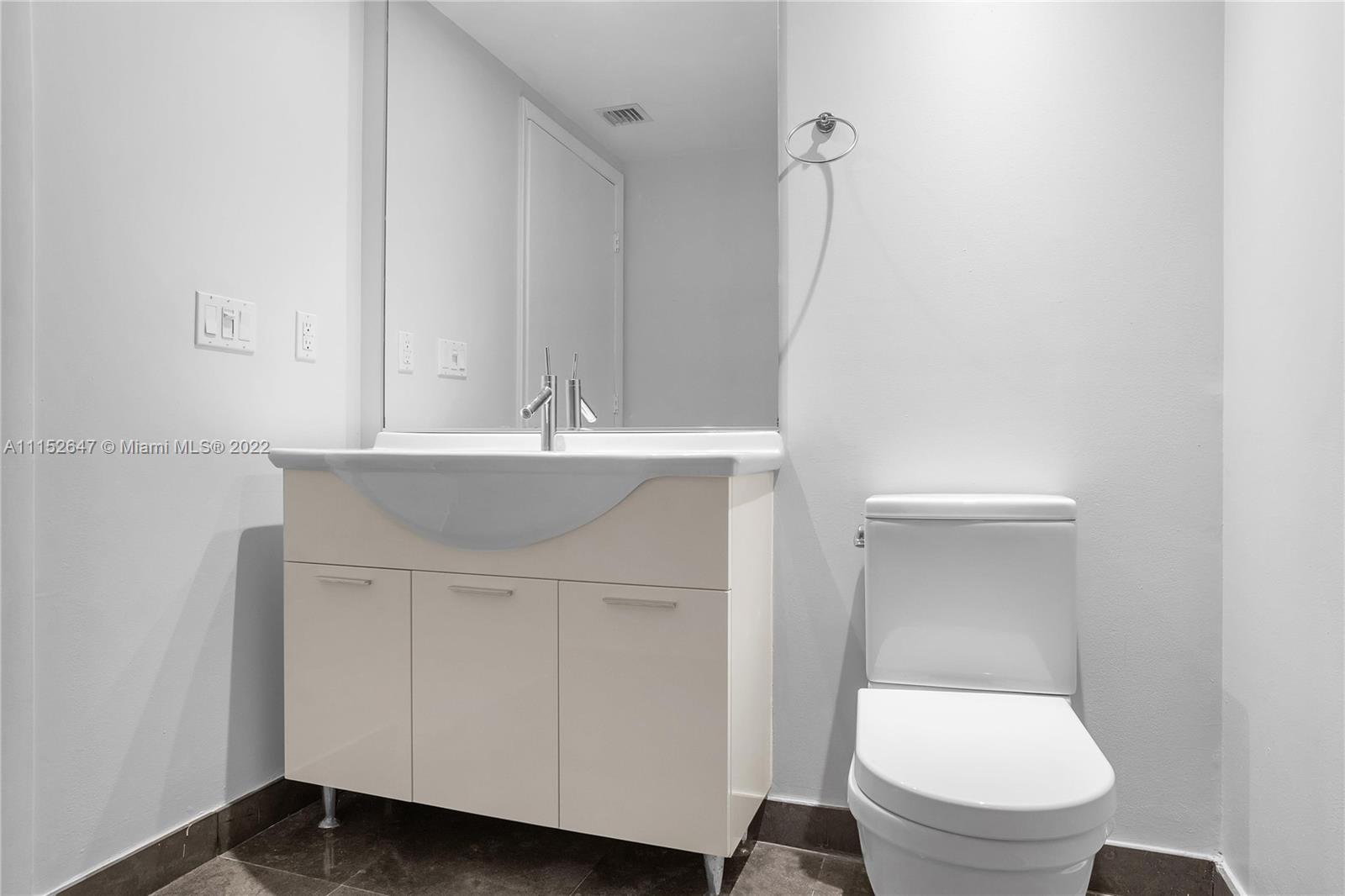 465 Brickell Avenue, Unit 5002 Miami, FL 33131 - Photo 26 of 26 a bathroom with a sink a toilet and a mirror