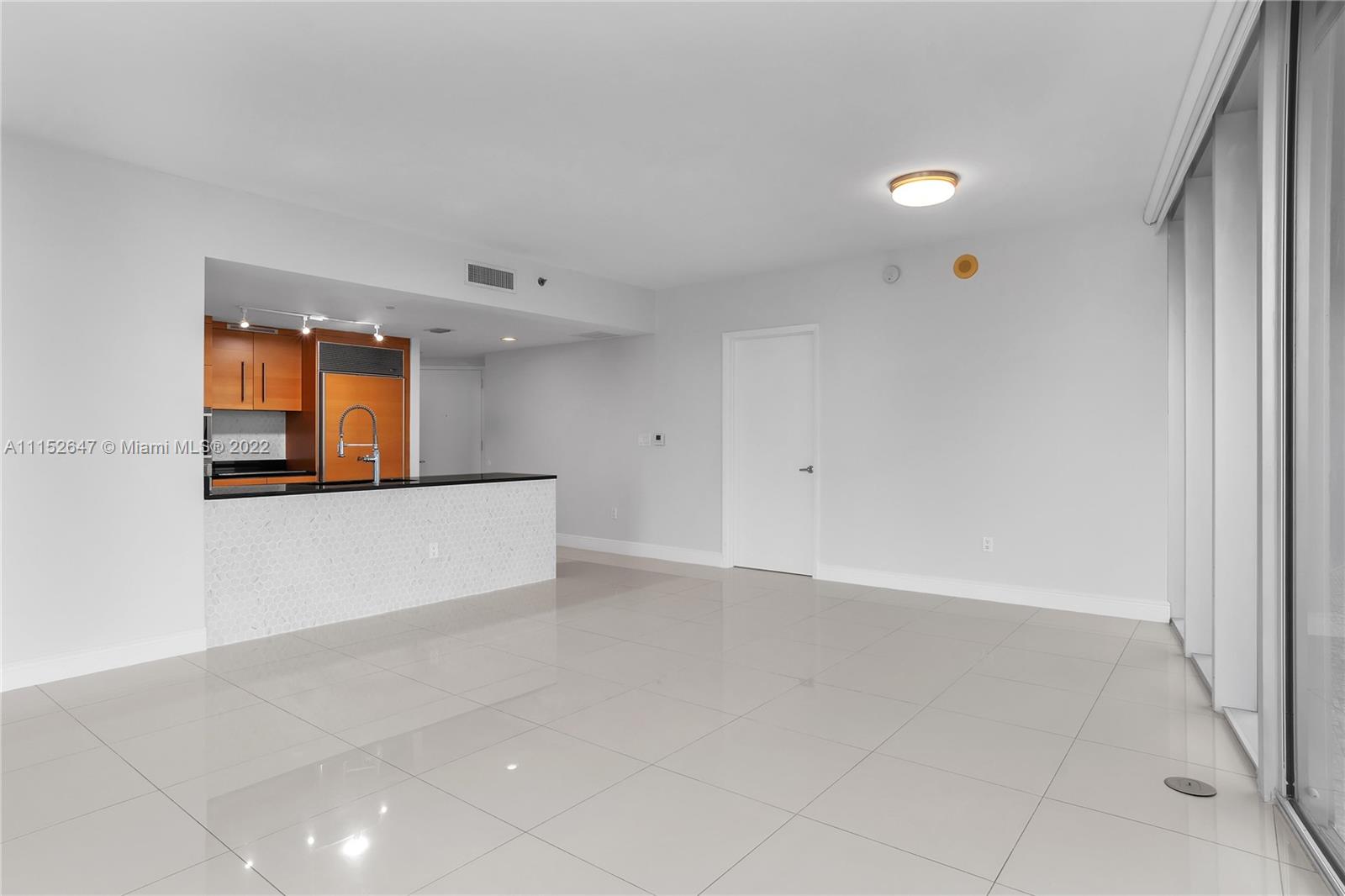 465 Brickell Avenue, Unit 5002 Miami, FL 33131 - Photo 10 of 26 an empty room with a window and a mirror