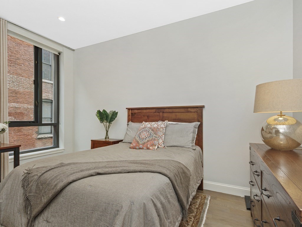 346 Congress Street, Unit 302 Boston, MA 02210 - Photo 13 of 22 a bedroom with a bed and window
