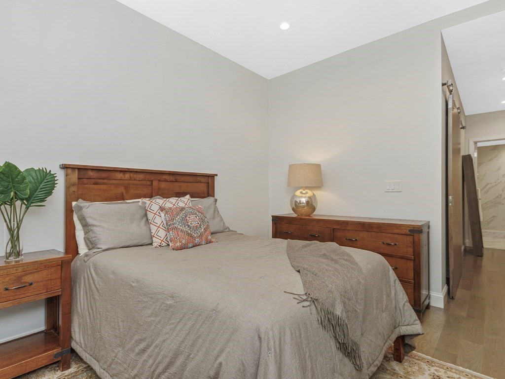346 Congress Street, Unit 302 Boston, MA 02210 - Photo 14 of 22 a bedroom with a bed and a night stand