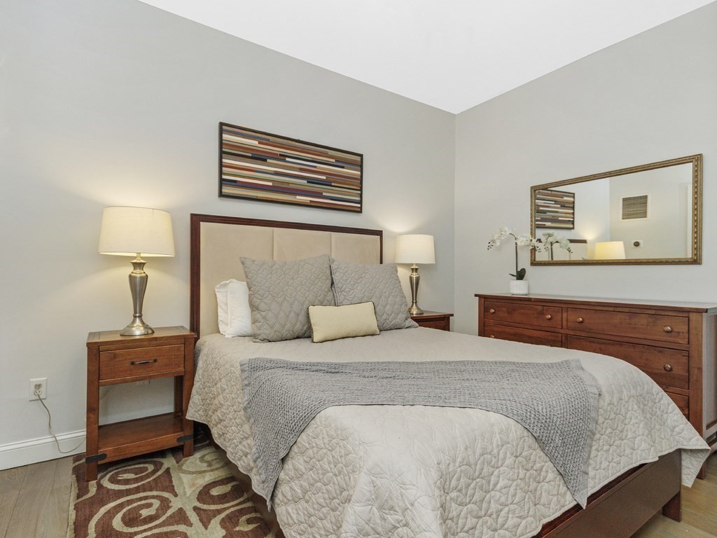 346 Congress Street, Unit 302 Boston, MA 02210 - Photo 16 of 22 a bedroom with a bed and a night stand