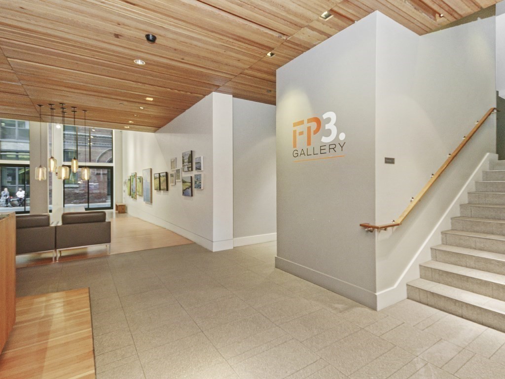 346 Congress Street, Unit 302 Boston, MA 02210 - Photo 4 of 22 a view of a livingroom with furniture and stairs