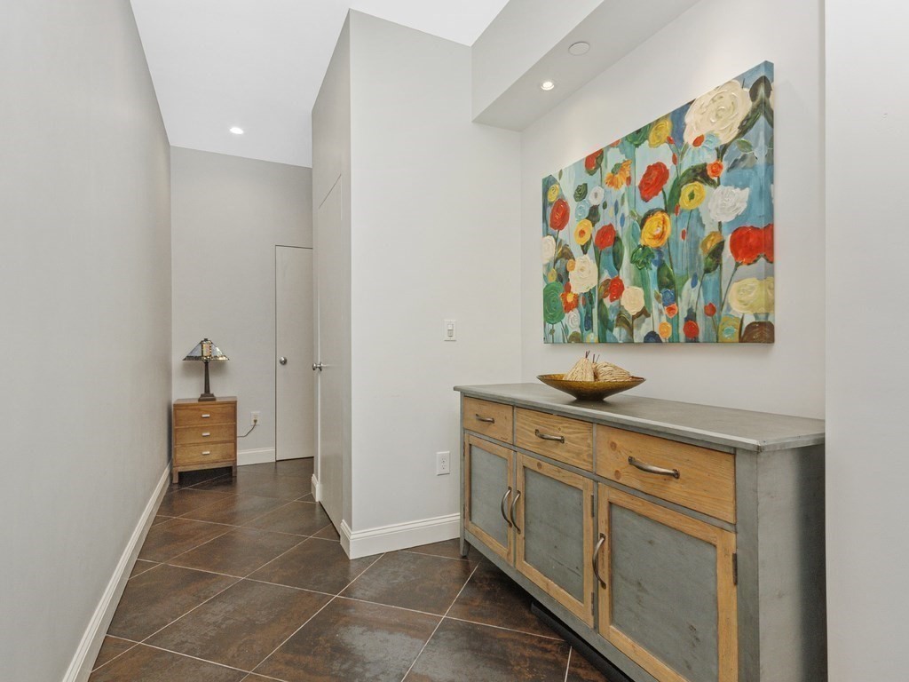 346 Congress Street, Unit 302 Boston, MA 02210 - Photo 6 of 22 a view of a hallway with painting on the wall