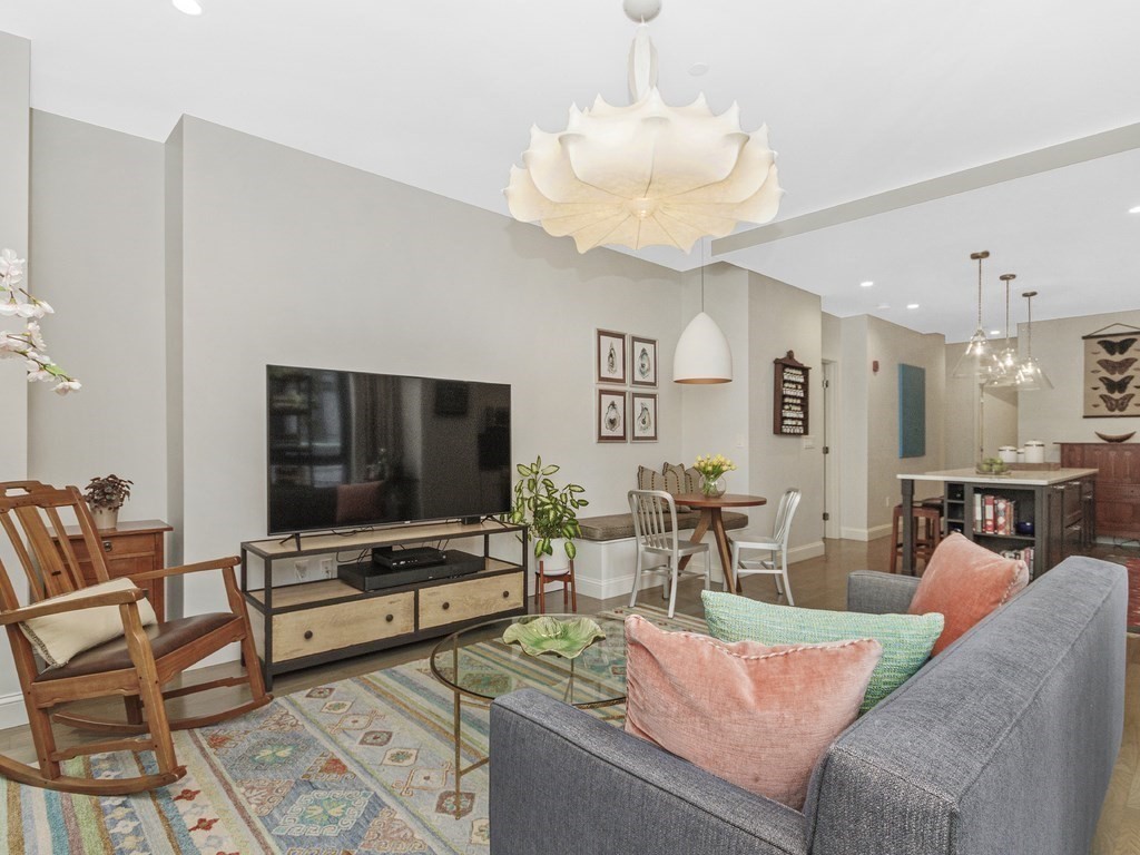 346 Congress Street, Unit 302 Boston, MA 02210 - Photo 9 of 22 a living room with furniture and a flat screen tv
