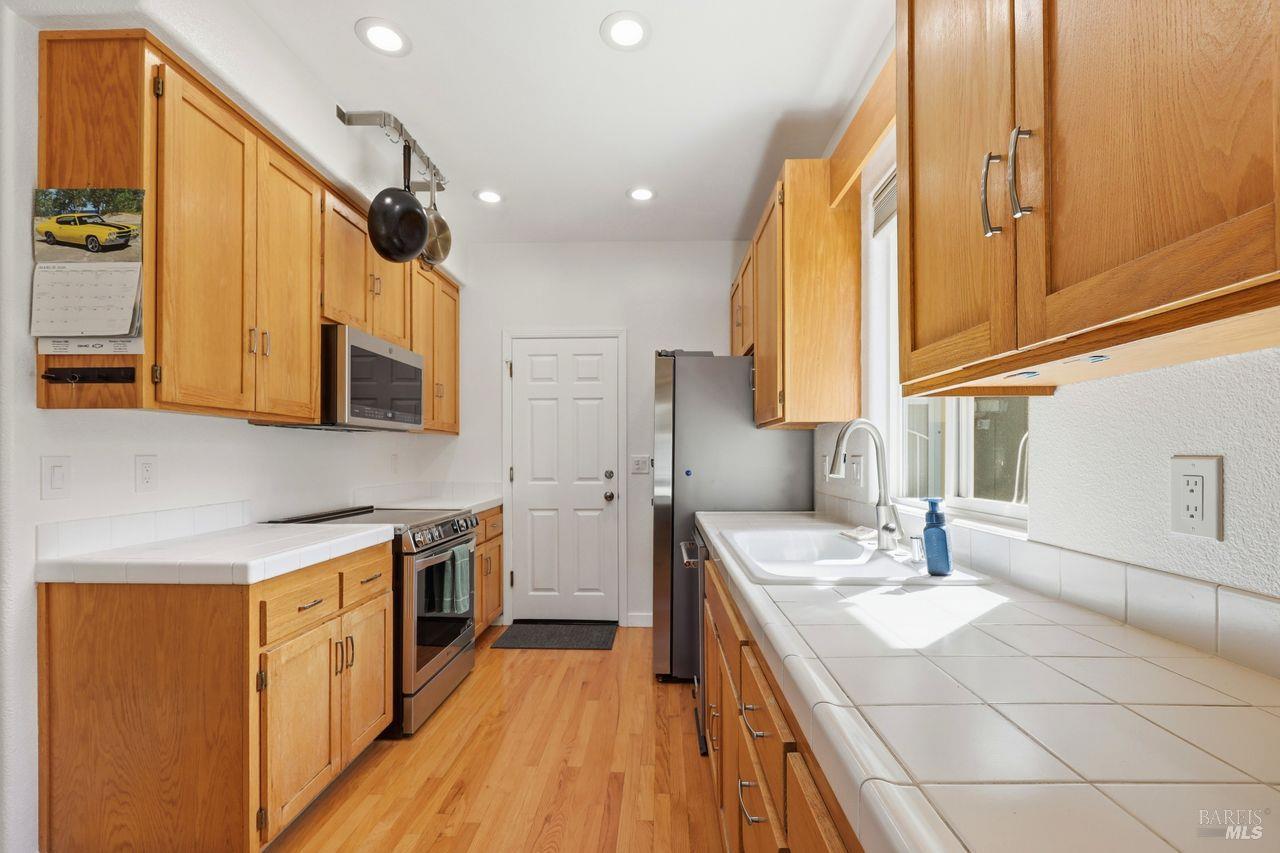 164 Fulton Place Windsor, CA 95492 - Photo 13 of 50 a kitchen with a sink stove and cabinets