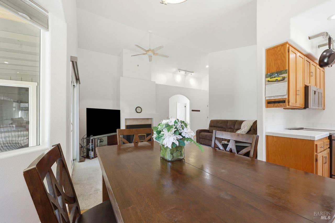 164 Fulton Place Windsor, CA 95492 - Photo 15 of 50 a dining room with wooden floor a chandelier a glass table and chairs