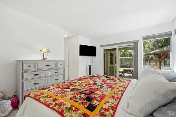 a bedroom with a bed and a large window