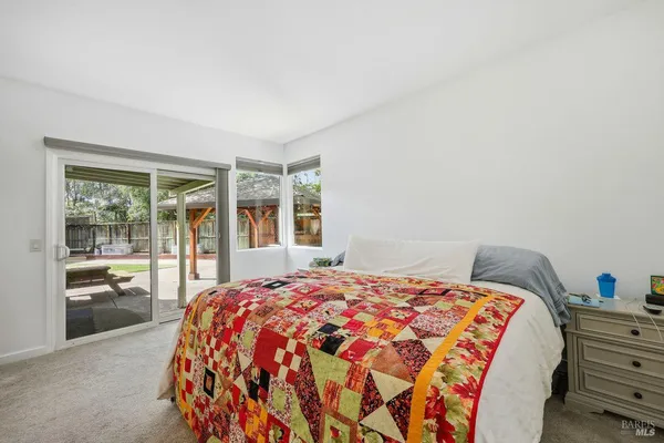 a bedroom with bed and a window