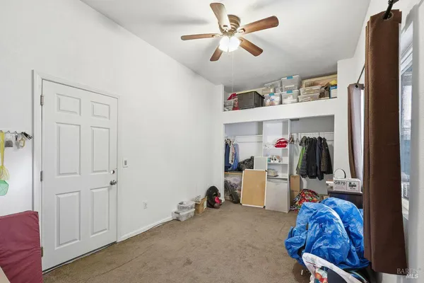 a bedroom with furniture and a window