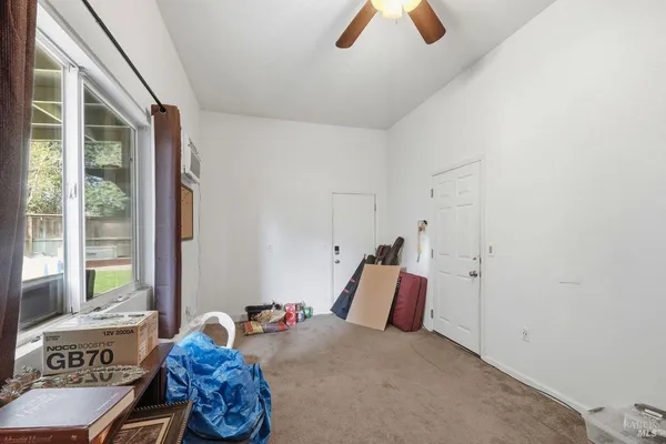 a bedroom with furniture and a large window