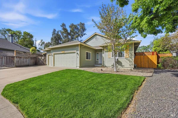 a front view of house with yard and green space
