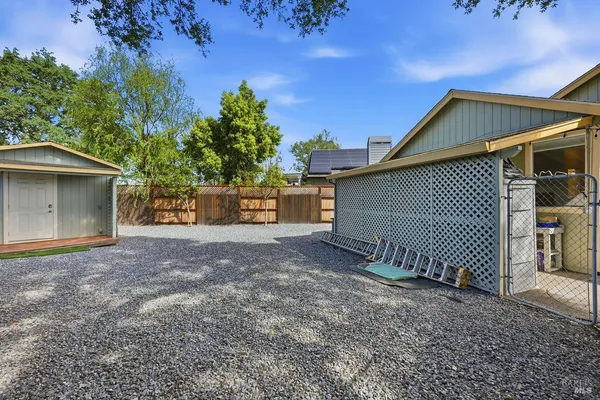 a view of a house with a yard and tree
