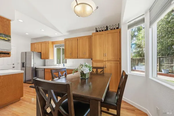 a kitchen with refrigerator and cabinets