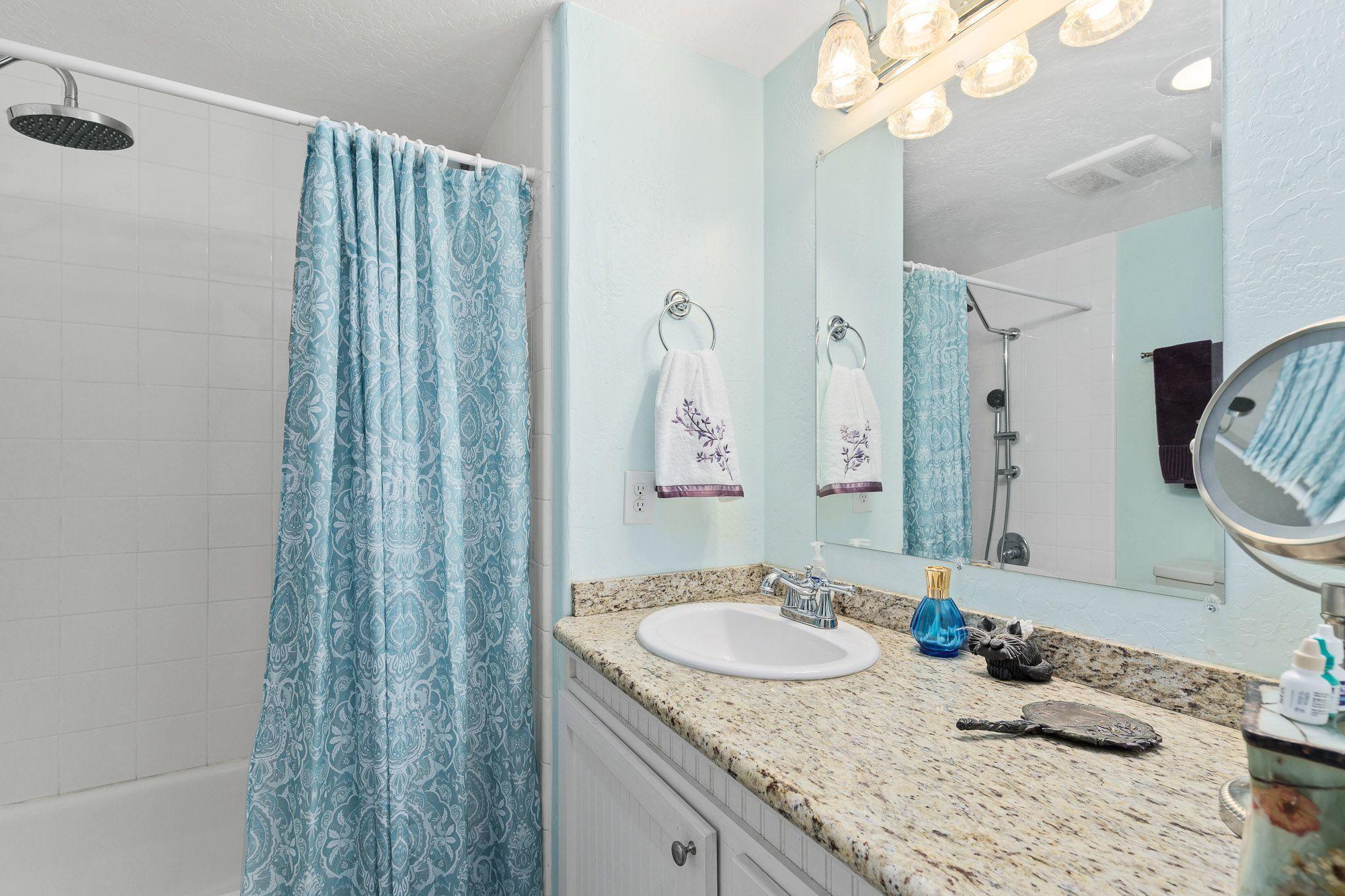 9266 Lower River Road Grants Pass, OR 97526 - Photo 18 of 39 a bathroom with a granite countertop sink a mirror and shower