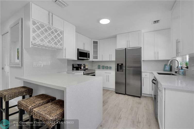 22341 Sea Bass Drive Boca Raton, FL 33428 - Photo 18 of 52 a kitchen with a refrigerator and a stove top oven