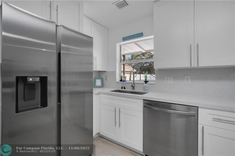 22341 Sea Bass Drive Boca Raton, FL 33428 - Photo 20 of 52 a kitchen with a sink and refrigerator