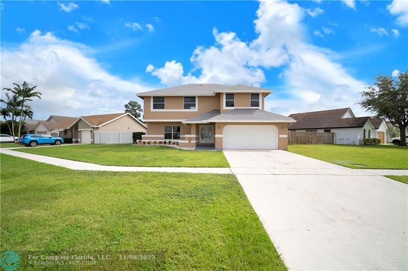 22341 Sea Bass Drive Boca Raton, FL 33428 - Photo 2 of 52 a front view of house with yard