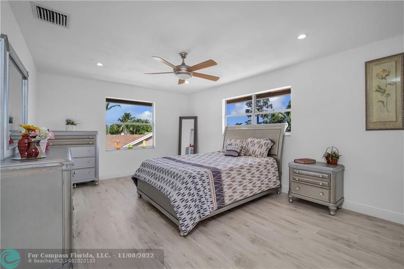 22341 Sea Bass Drive Boca Raton, FL 33428 - Photo 24 of 52 a bedroom with a bed and a chandelier