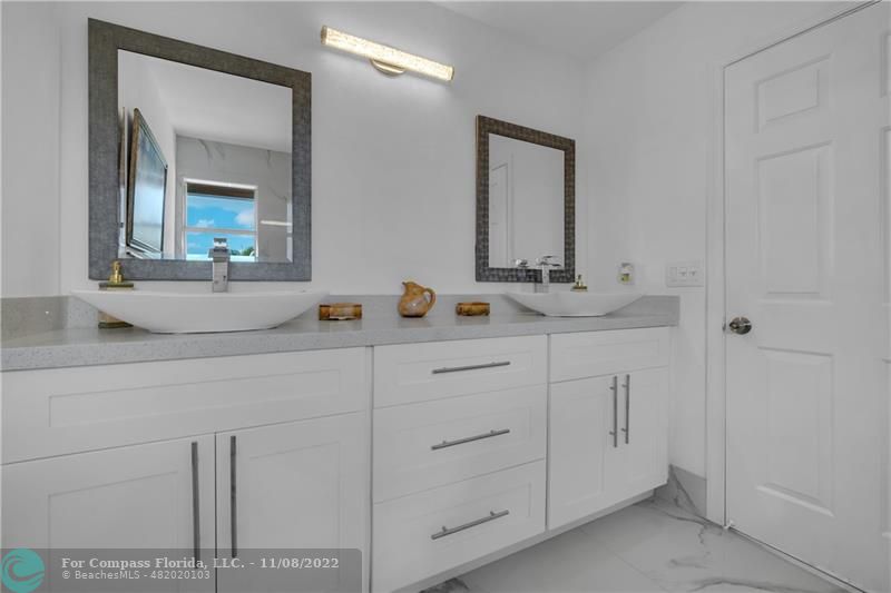 22341 Sea Bass Drive Boca Raton, FL 33428 - Photo 27 of 52 a bathroom with a sink and a mirror