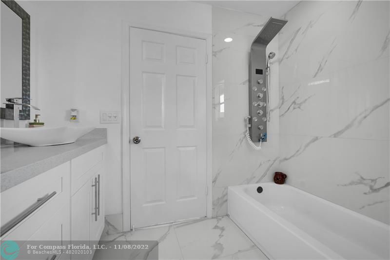22341 Sea Bass Drive Boca Raton, FL 33428 - Photo 28 of 52 a bathroom with a bathtub and shower
