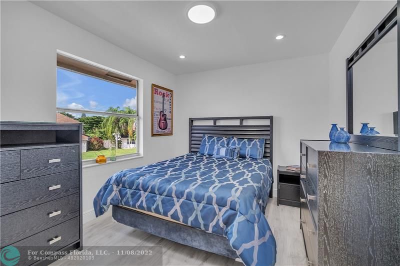 22341 Sea Bass Drive Boca Raton, FL 33428 - Photo 29 of 52 a bedroom with a bed and a dresser