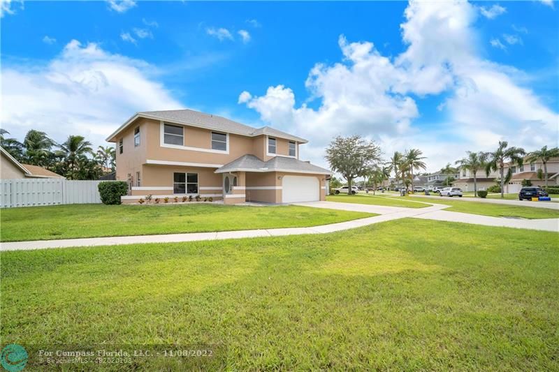22341 Sea Bass Drive Boca Raton, FL 33428 - Photo 3 of 52 a front view of house with yard and swimming pool