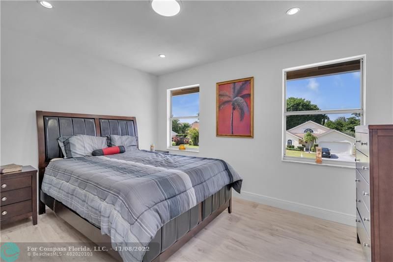 22341 Sea Bass Drive Boca Raton, FL 33428 - Photo 31 of 52 a bedroom with a bed and a painting on the wall