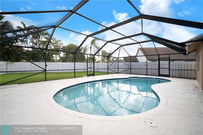 22341 Sea Bass Drive Boca Raton, FL 33428 - Photo 36 of 52 a view of a swimming pool with a patio