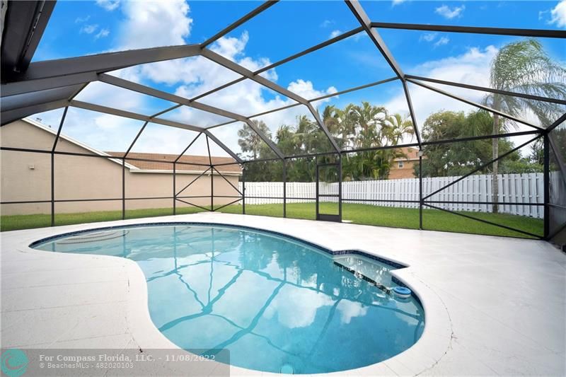 22341 Sea Bass Drive Boca Raton, FL 33428 - Photo 39 of 52 a view of a swimming pool with a backyard
