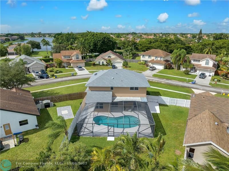 22341 Sea Bass Drive Boca Raton, FL 33428 - Photo 42 of 52 an aerial view of a house with a garden and lake view