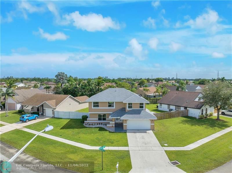 22341 Sea Bass Drive Boca Raton, FL 33428 - Photo 6 of 52 a view of a house with swimming pool and mountains in the background