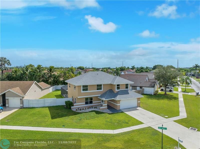 22341 Sea Bass Drive Boca Raton, FL 33428 - Photo 7 of 52 a aerial view of a house with swimming pool garden and lake view