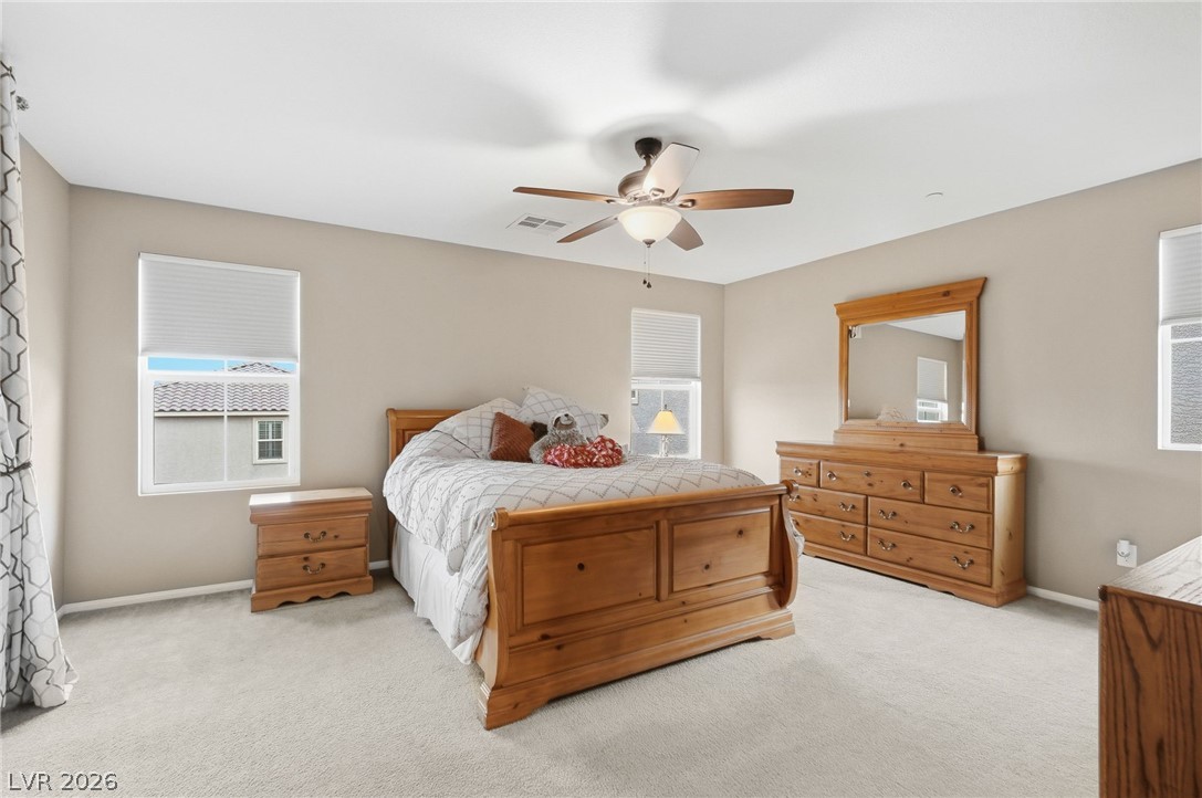 150 Fulgora Street Henderson, NV 89074 - Photo 46 of 92 Bedroom with light carpet and ceiling fan