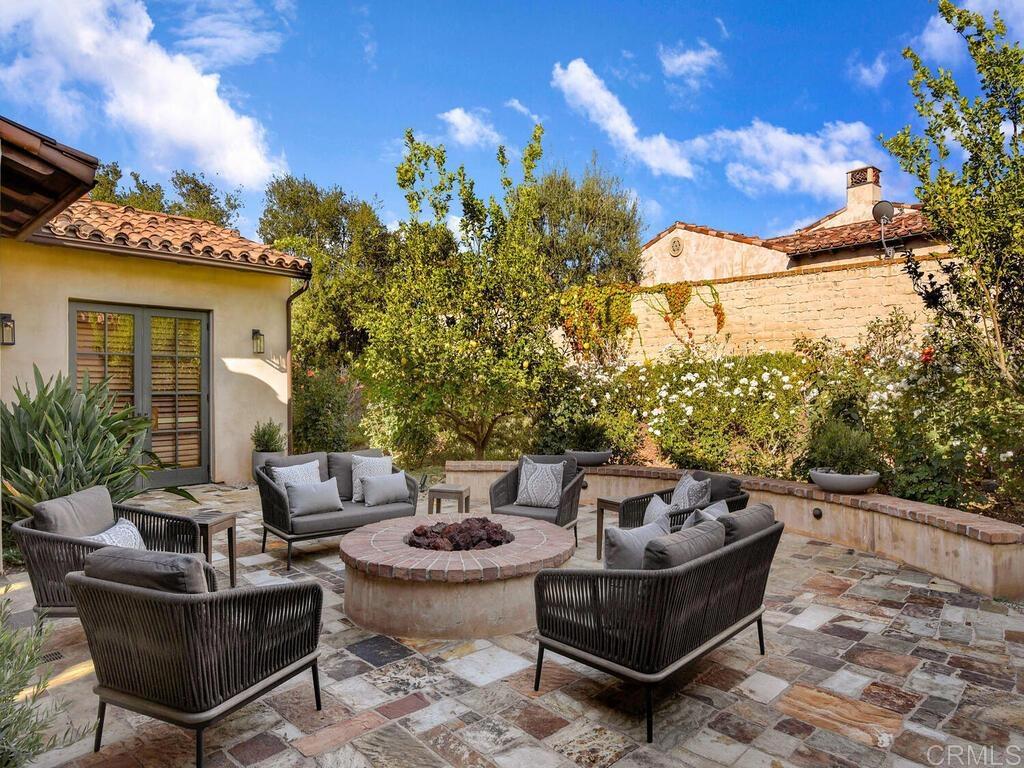 4272 Via Ravello Rancho Santa Fe, CA 92091 - Photo 21 of 58 a view of a patio with couches table and chairs and potted plants