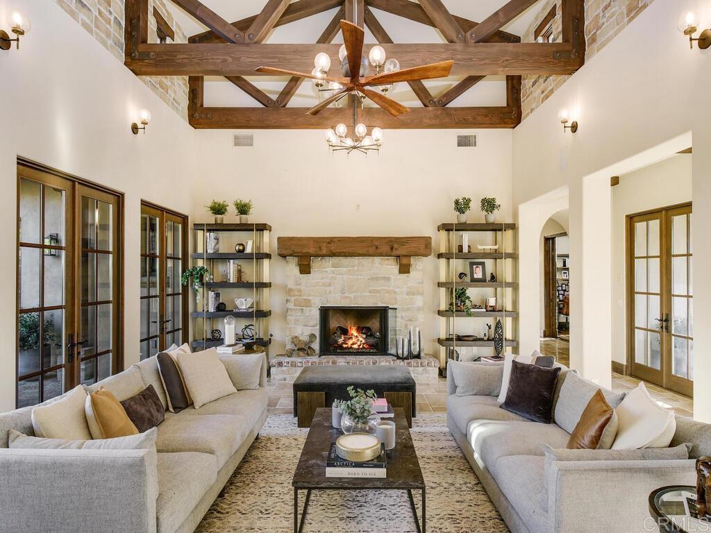 4272 Via Ravello Rancho Santa Fe, CA 92091 - Photo 23 of 58 a living room with furniture a fireplace and a ceiling fan