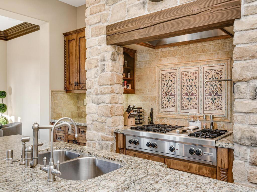 4272 Via Ravello Rancho Santa Fe, CA 92091 - Photo 25 of 58 a kitchen with stainless steel appliances granite countertop a sink stove and cabinets