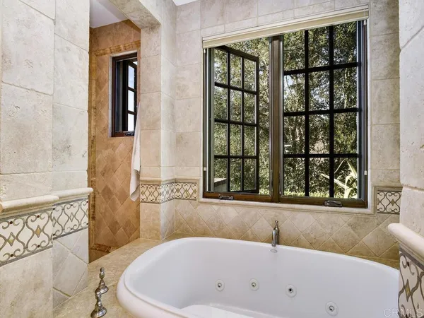 a bedroom with two beds and a large window