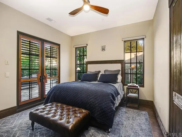 a bedroom with a bed and a television