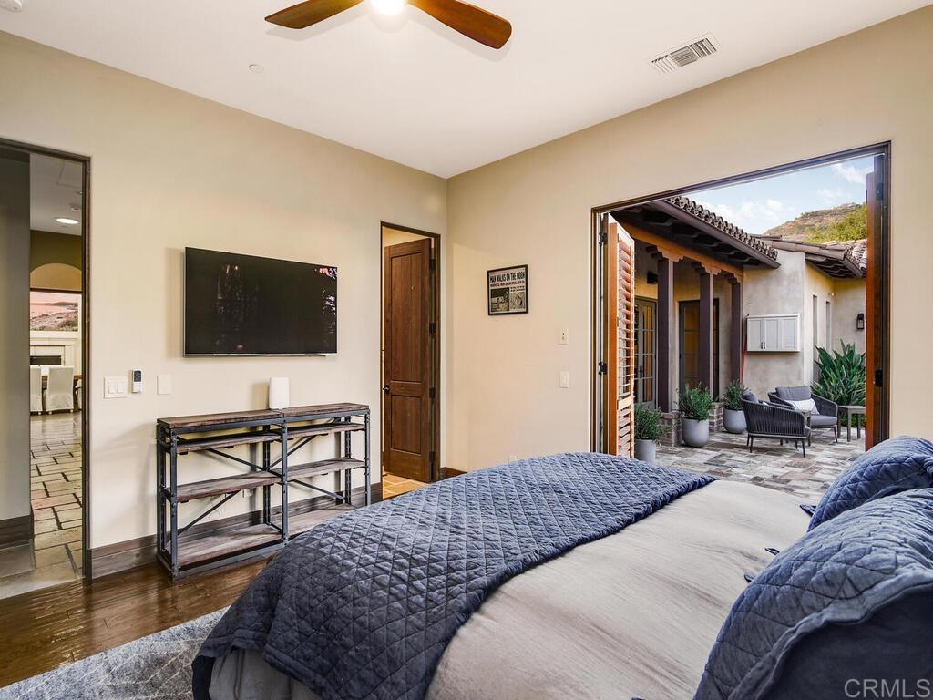 4272 Via Ravello Rancho Santa Fe, CA 92091 - Photo 36 of 58 a bedroom with a bed and a flat screen tv