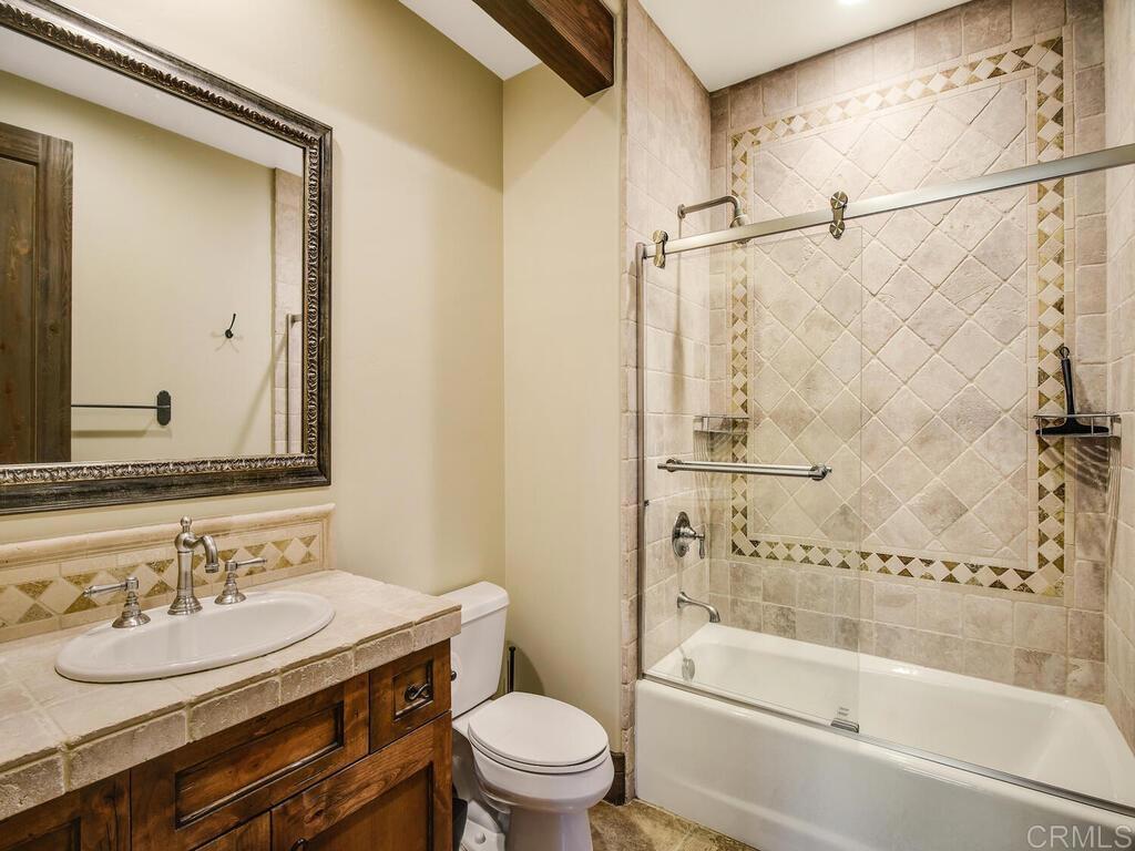 4272 Via Ravello Rancho Santa Fe, CA 92091 - Photo 37 of 58 a bathroom with a granite countertop sink toilet and shower