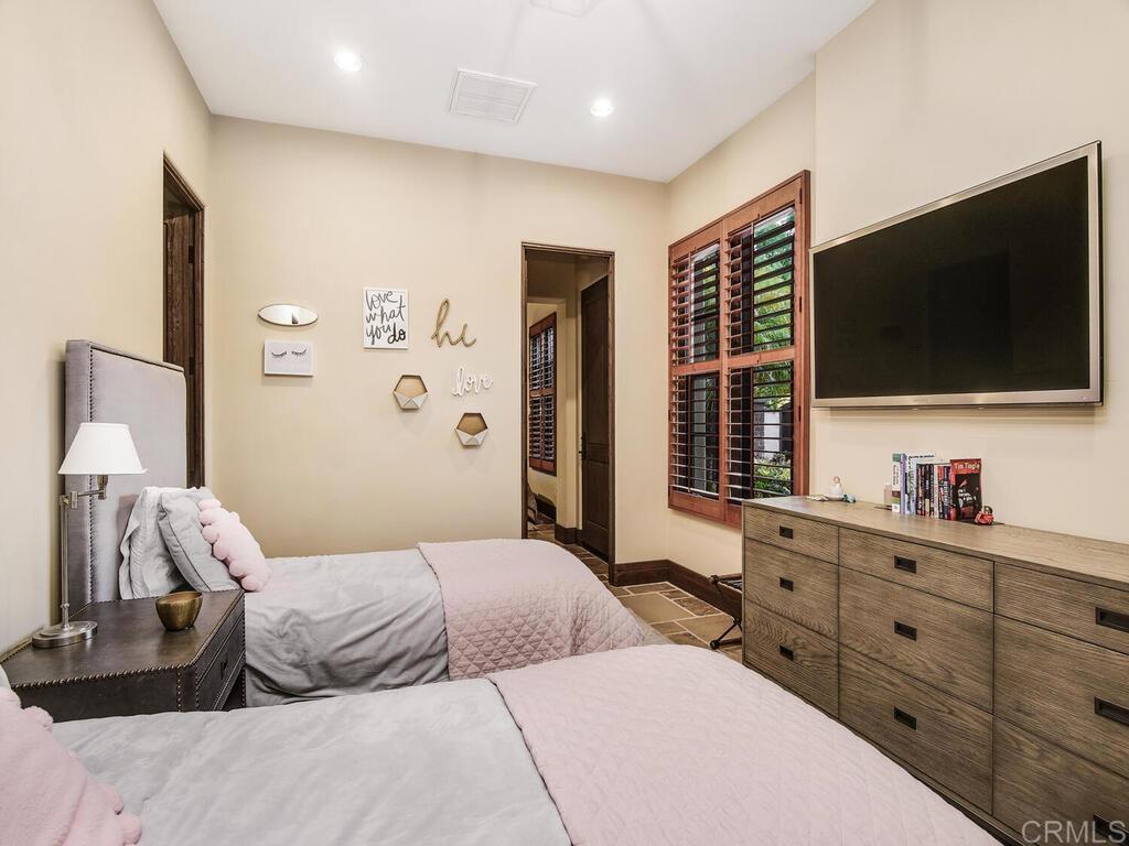 4272 Via Ravello Rancho Santa Fe, CA 92091 - Photo 42 of 58 a bedroom with a large bed and a flat screen tv