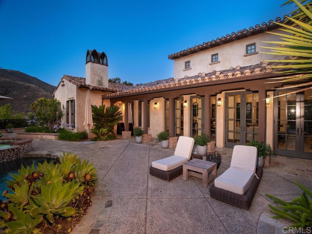 4272 Via Ravello Rancho Santa Fe, CA 92091 - Photo 47 of 58 a view of a patio with couches table and chairs and potted plants